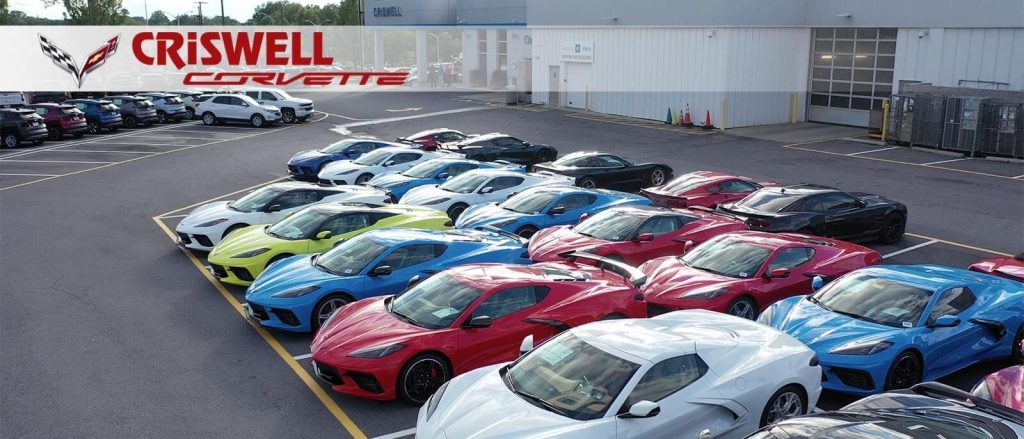 Wide view of multiple Chevrolet Corvette vehicles in various colors lined up at Criswell Corvette dealership in Gaithersburg, Maryland, showcasing extensive inventory and customization options.