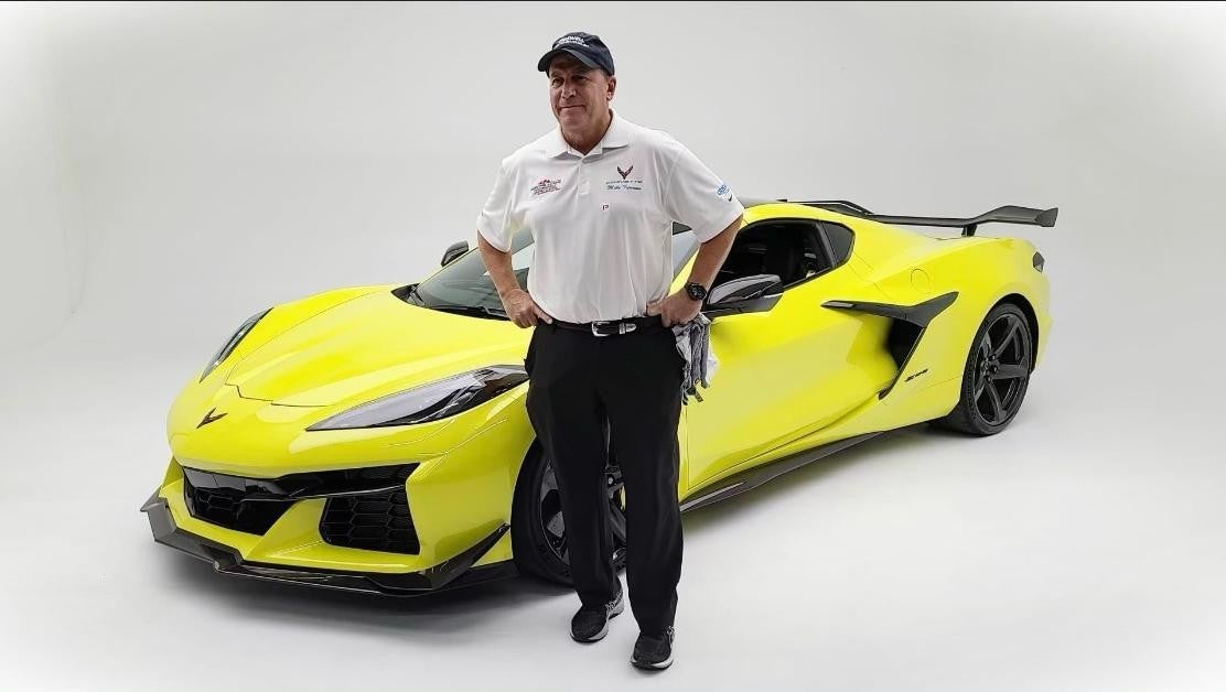 Mike Furman next to yellow Corvette