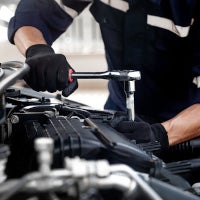 mechanic working on car engine